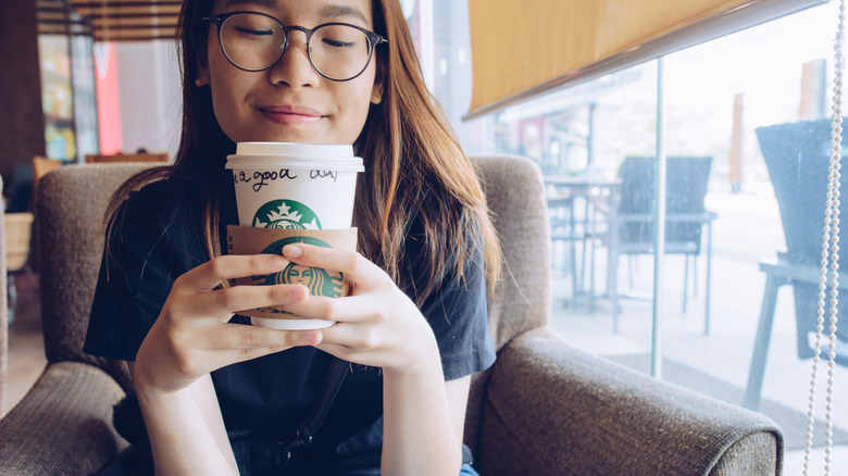 woman with starbucks coffee cup