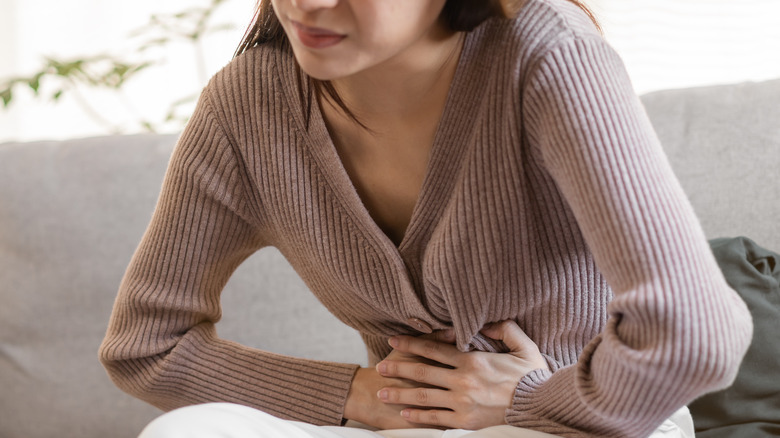 woman suffering from diverticular disease symptoms