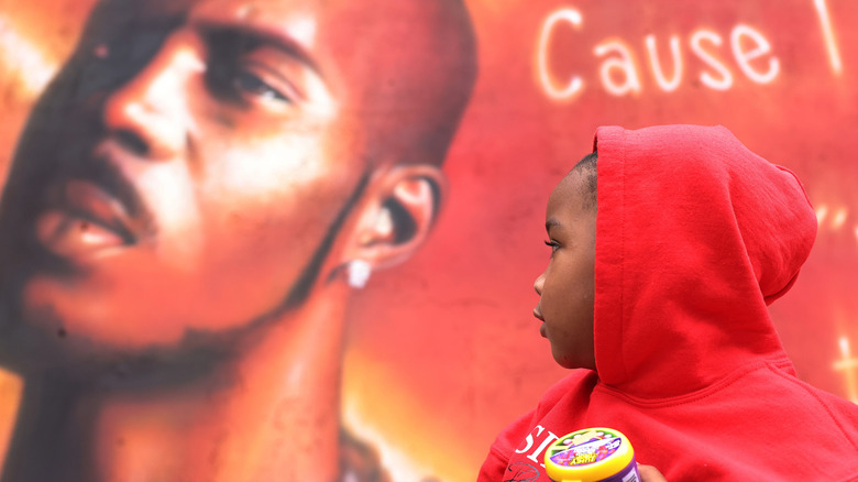 DMX's son Exodus looks on at mural of DMX