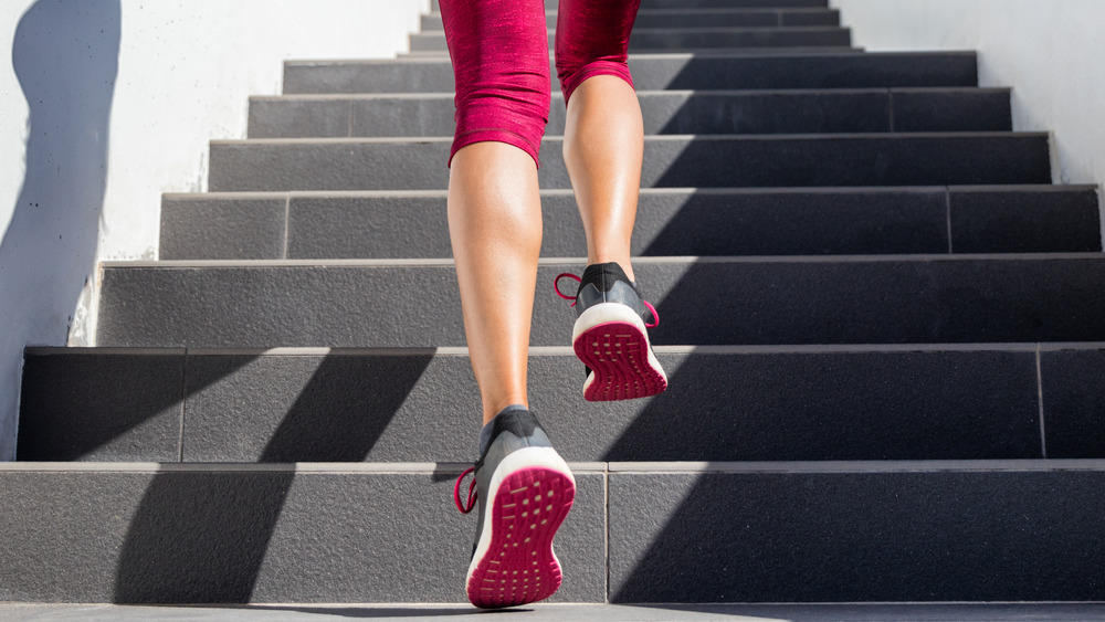 woman running up steps