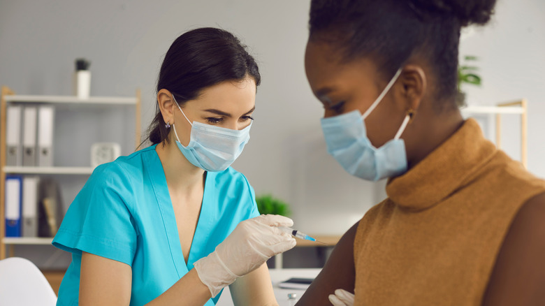 A woman gets a COVID-19 vaccine