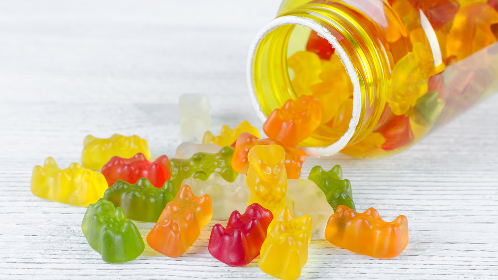 gummy vitamins spilling out of a jar