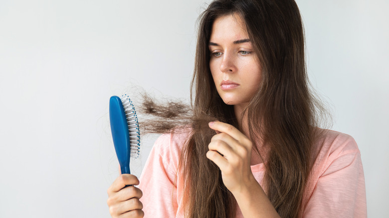 A woman is losing hair because of a vitamin deficiency