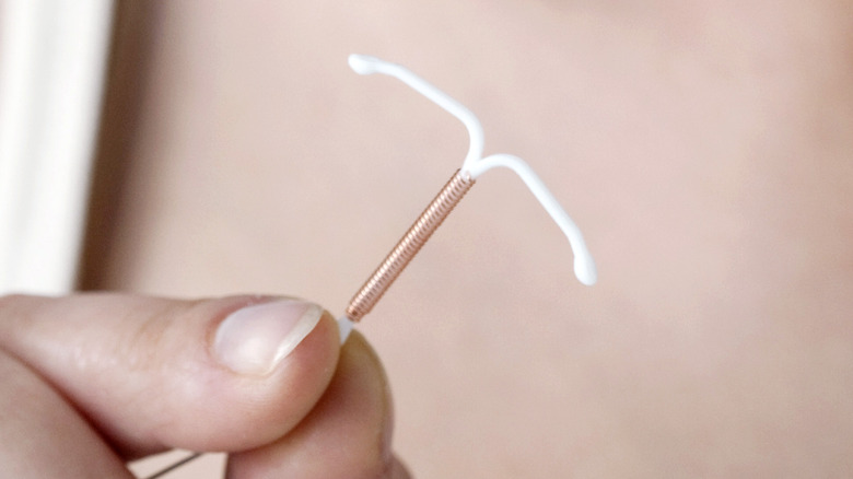 Woman holding copper IUD 