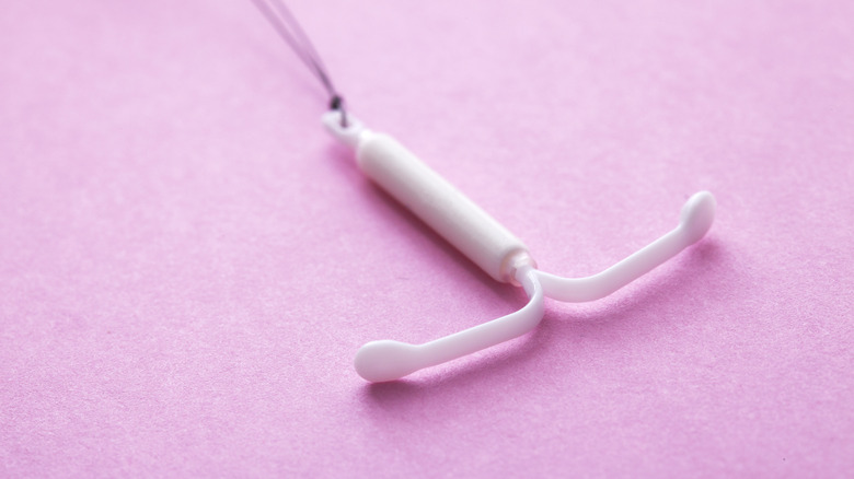 Hormonal IUD on pink paper