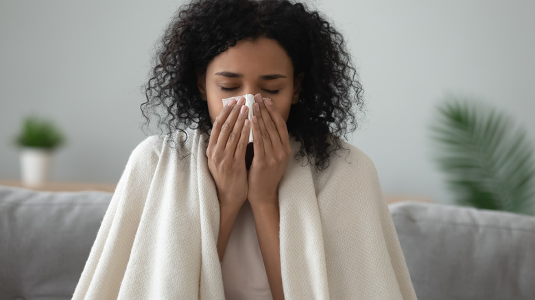 Woman blowing nose