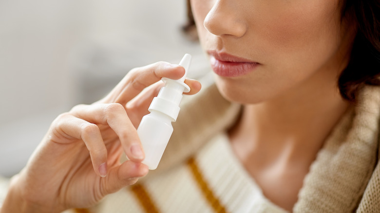 woman using nasal spray