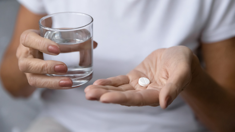 woman taking pill