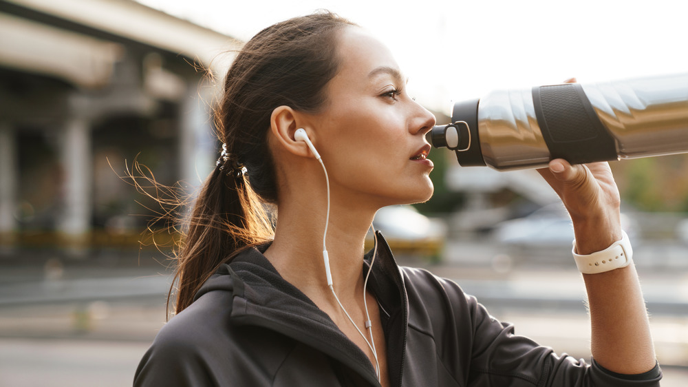 woman sipping sports drink