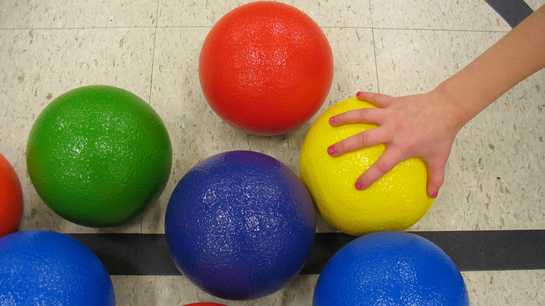 A hand reaching for a dodgeball