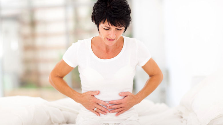 Woman holding her stomach in pain