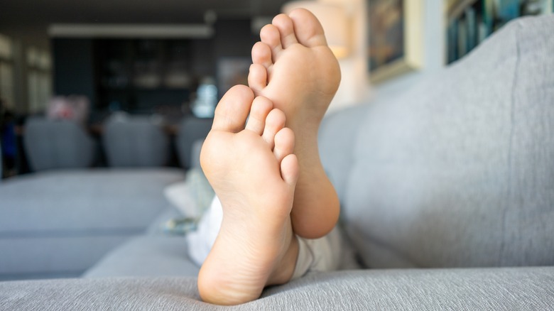 Bare feet laying on couch