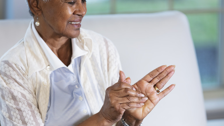 Smiling woman rubbing hands together