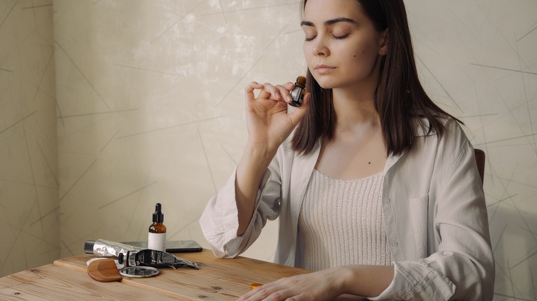 Woman smelling essential oil