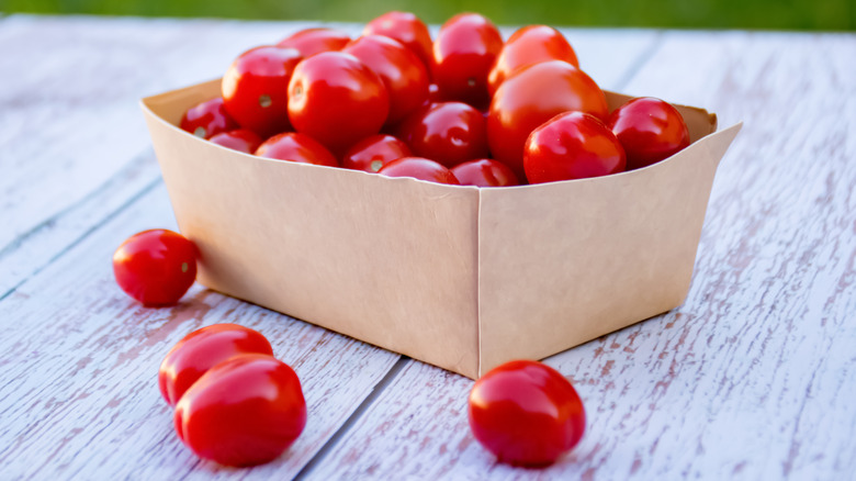 box of tomatoes on picnic table