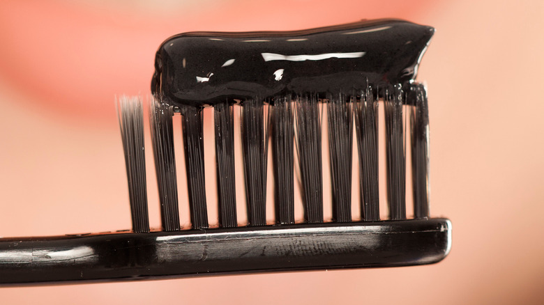 Charcoal toothpaste on toothbrush