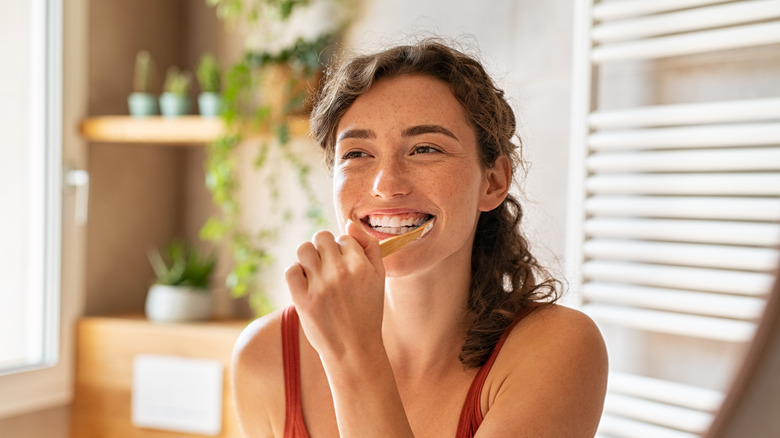 Woman brushing teeth