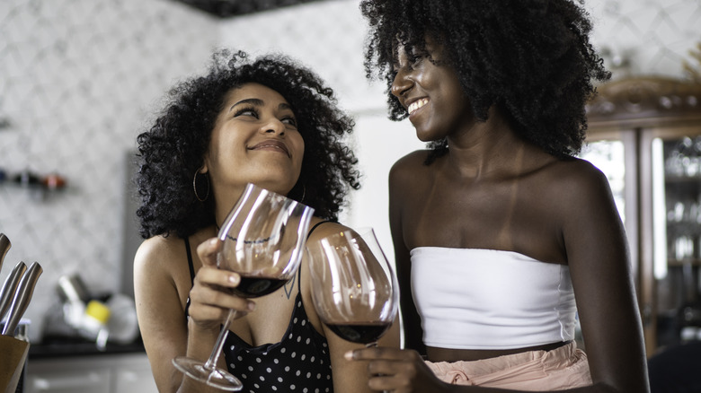 two women toasting with red wine