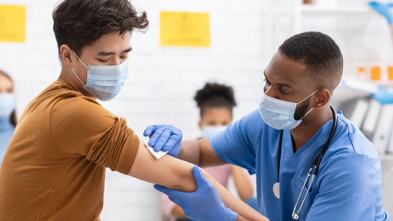 A medical provider giving a patient a vaccine injection