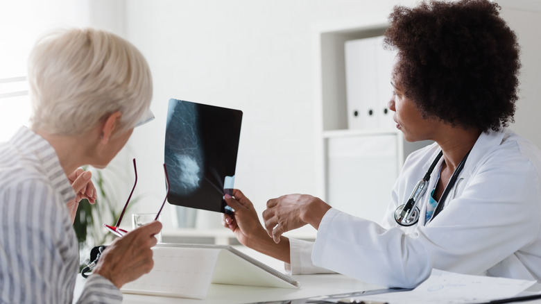 Doctor examining x-ray with patient
