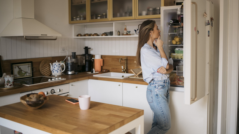 woman carrying healthy and unhealthy foods