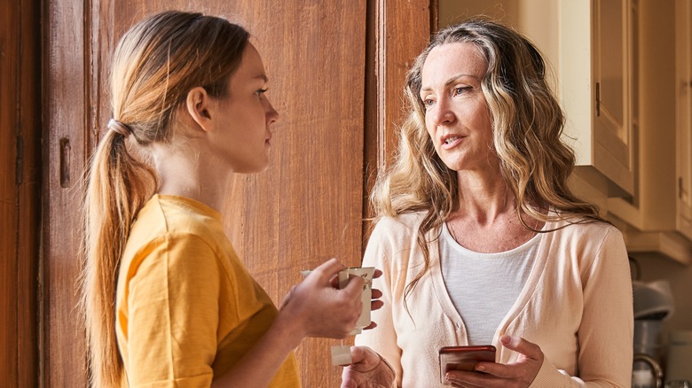 woman talking seriously with her teenage daughter