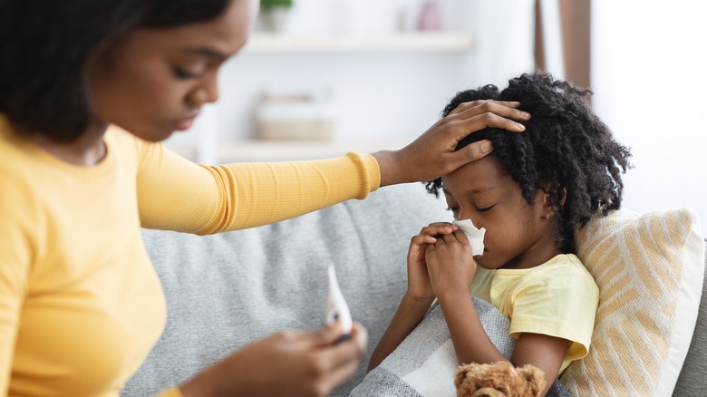 Mother taking child's temperature