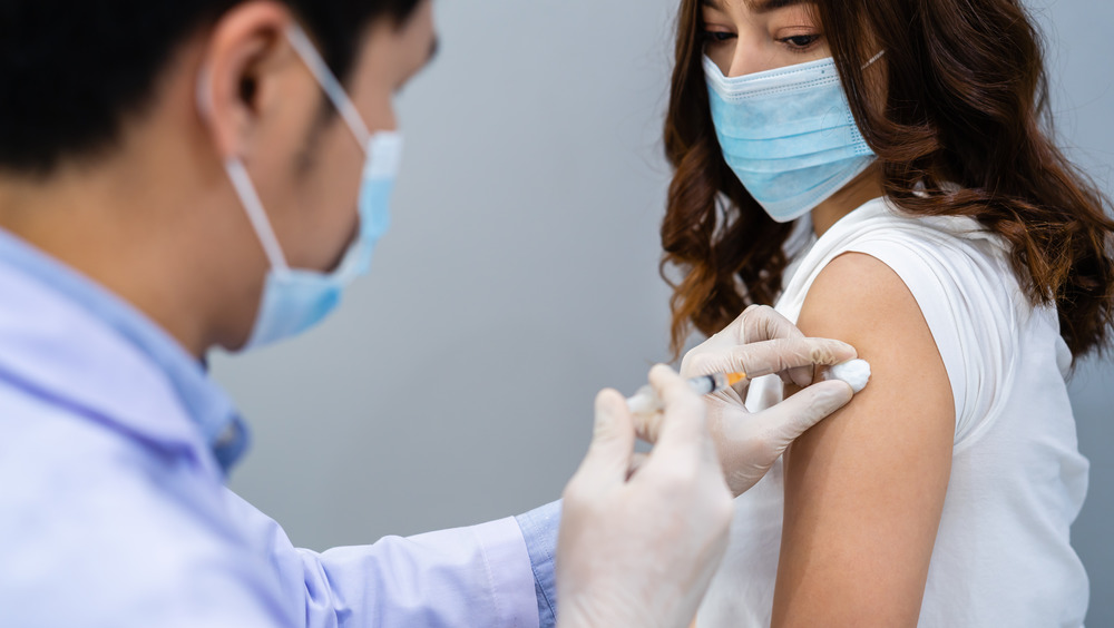 A woman receiving a vaccine