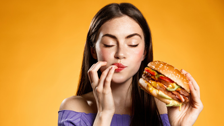 woman eating hamburger