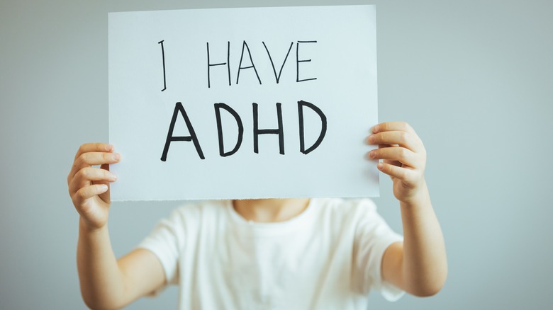 Boy holding ADHD sign