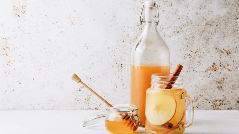Bottle and glass of apple cider vinegar
