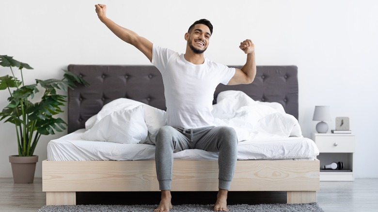 Man waking up happy from sleep