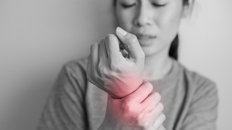 woman holding wrist in pain