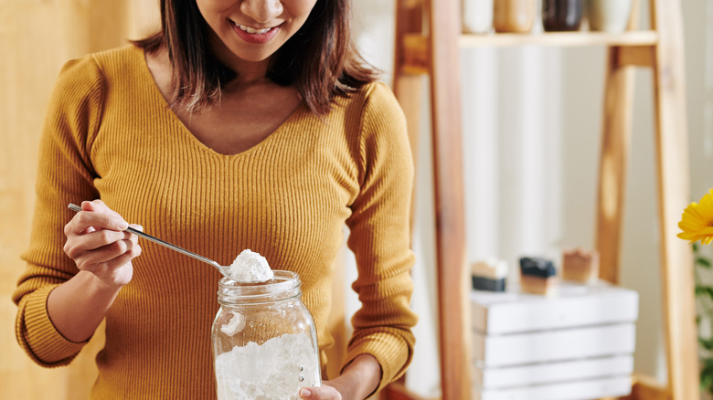 Woman holding jar of baking soda