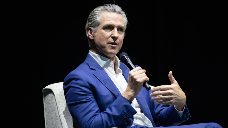 California Gov. Gavin Newsom sitting at an event promoting his book "Young Man in a Hurry"