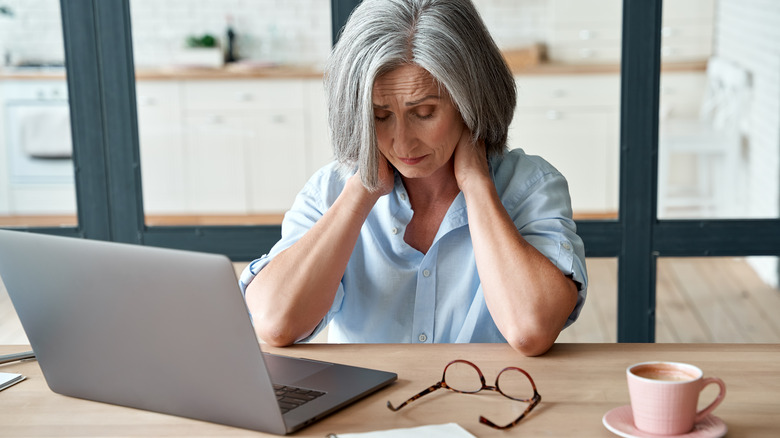 A woman tired at desk