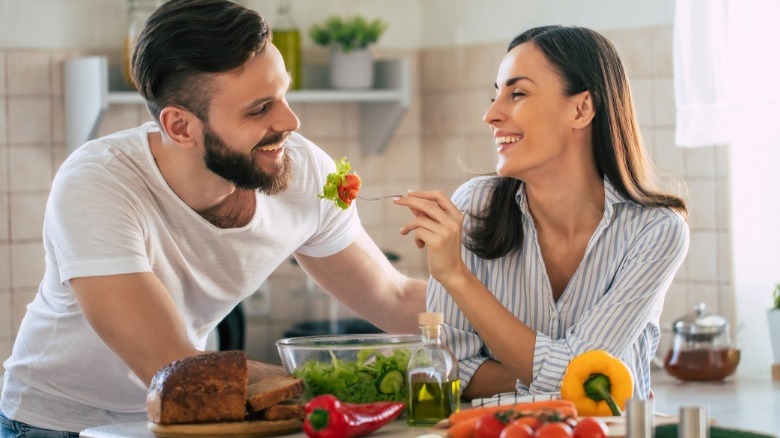 young couple eating salad
