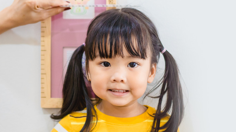 Little girl being measured