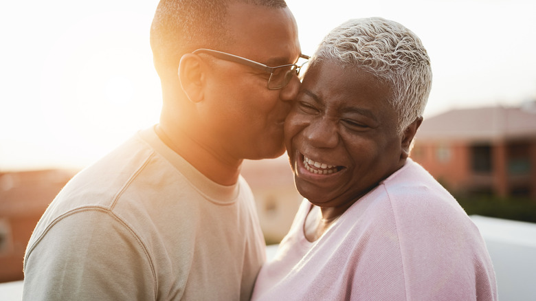 Man kissing woman