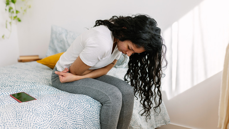 woman folded over holding her stomach