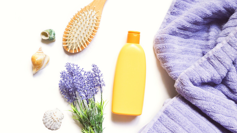 lavender, lavender oil, a brush and towel 