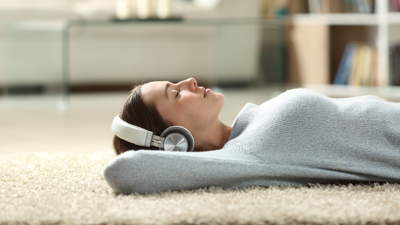 Relaxed woman on the floor listening to music