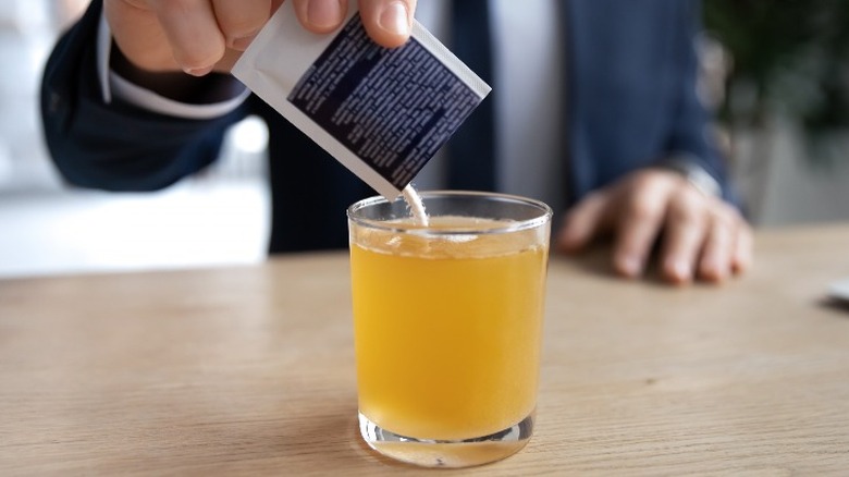 man dissolving medication hot water