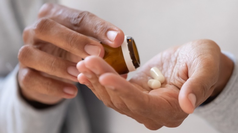 african american woman pouring pills