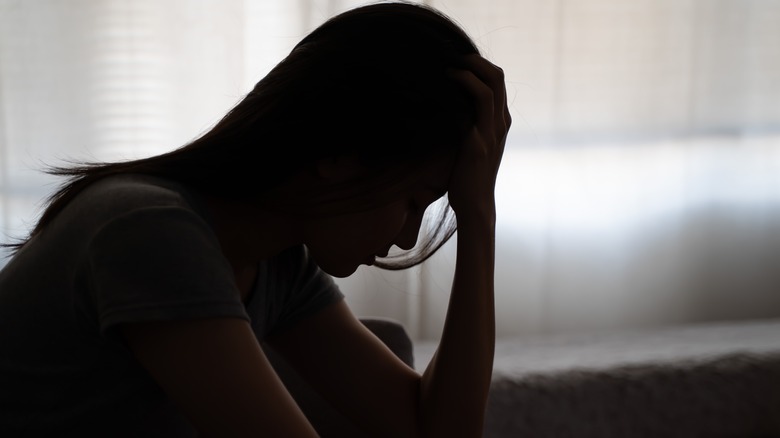 Silhouette of distressed woman