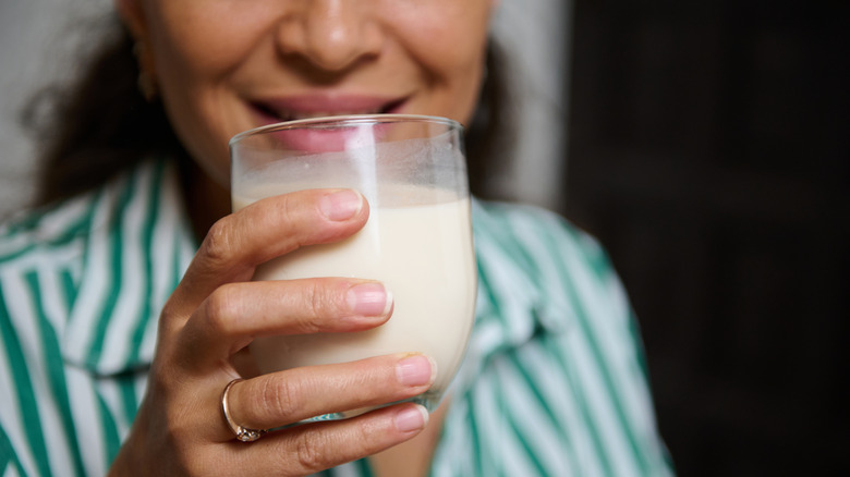 woman drinking a glass of milk