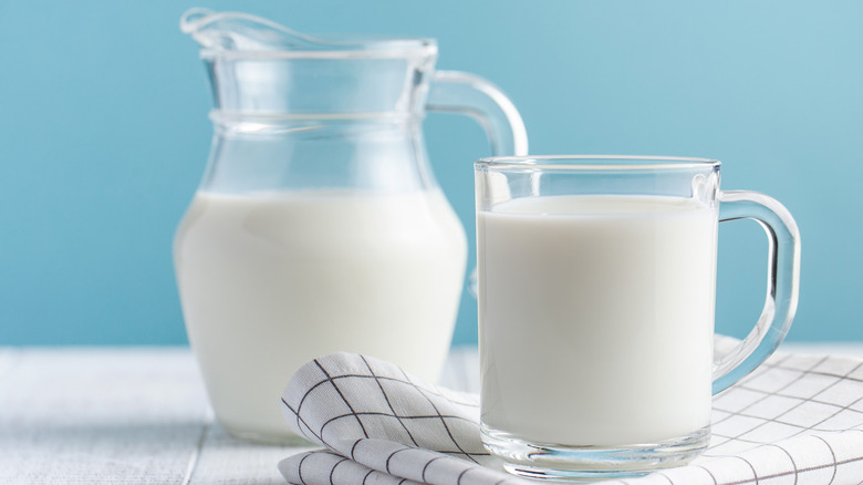 Glass and pitcher of milk