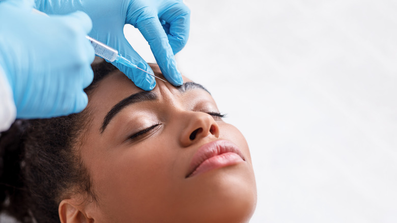 Woman getting Botox on forehead