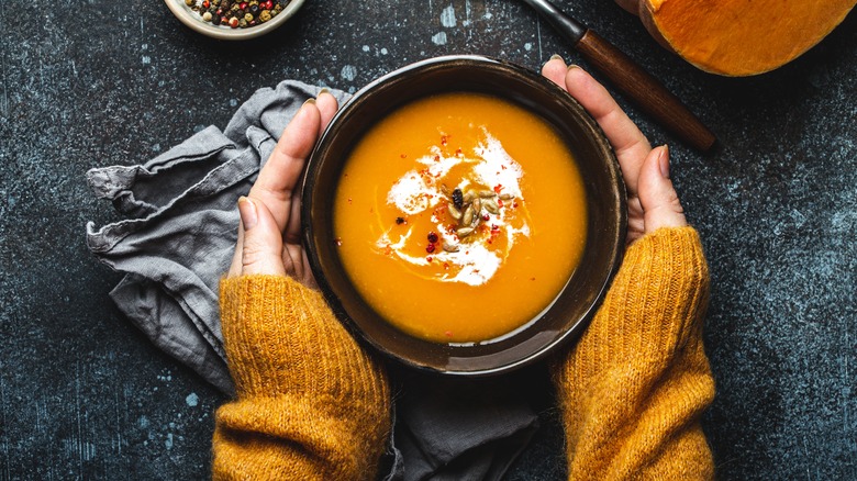 person holding bowl of soup