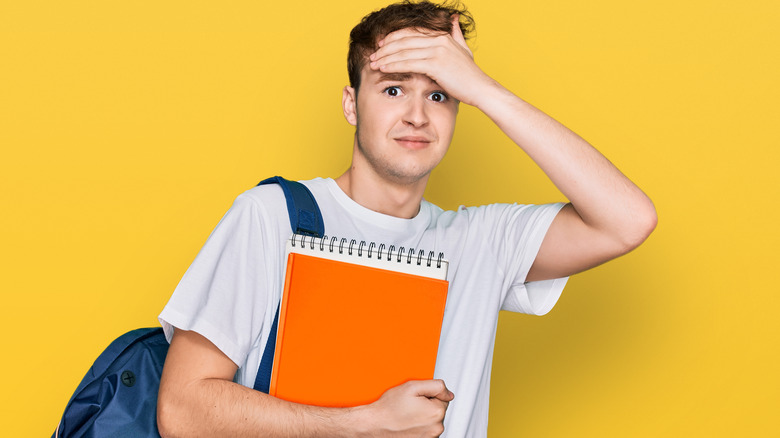 Guy covering his forehead